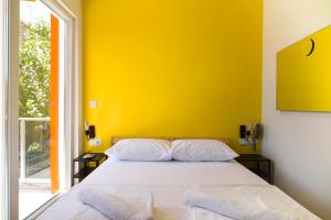 a bedroom with a bed with a yellow wall at Belsun Hotel in Beldibi
