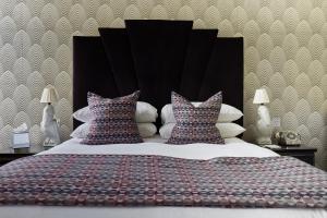 A bed or beds in a room at Angel Hotel 