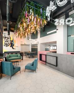 a lobby with chairs and a chandelier at Colors Hotel Athens in Athens