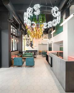 a lobby with chairs and a chandelier at Colors Hotel Athens in Athens