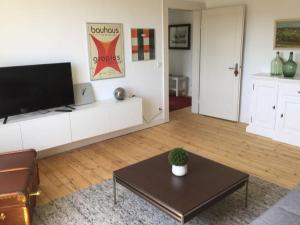 a living room with a television and a coffee table at Attendorner Burgblick in Attendorn