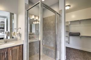 a glass shower in a bathroom with a sink at Luxury Downtown Moab Townhome with Pool Access! in Moab +19 photos