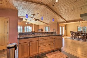 a kitchen with wooden cabinets and a dining room at Prescott Home Less Than 5 Miles to Butte Creek Trail! in Prescott