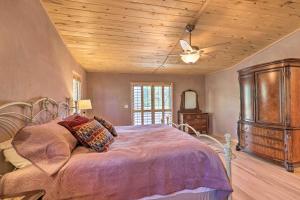a bedroom with a bed and a wooden ceiling at Prescott Home Less Than 5 Miles to Butte Creek Trail! in Prescott