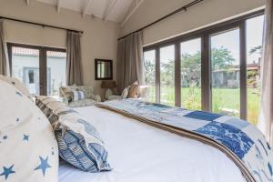 a bedroom with a large bed with blue stars on it at Veranda House Boutique Accommodation in Midrand +276 photos