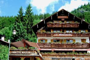 a large building with a bunch of windows on top of it at Hotel La Montagne in La Clusaz