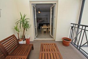 a balcony with a bench and a dining room at Promenada by Baltic Home in Świnoujście