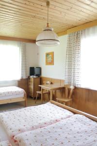 a bedroom with a bed and a desk and a table at Gasthof Zum heiligen Nikolaus in Haibach ob der Donau