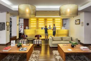 two men standing in the lobby of a hotel at Belmar Spa & Beach Resort in Lagos