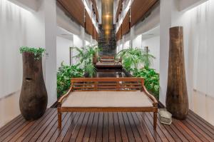 a bench sitting on a wooden floor in a building at Belmar Spa & Beach Resort in Lagos
