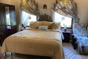 a bedroom with a large bed and a window at B-LBAIT Yanbu Villa Garden in Madīnat Yanbu‘ aş Şinā‘īyah
