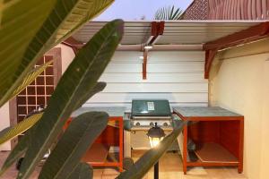 a table with a laptop on it next to a house at B-LBAIT Yanbu Villa Garden in Madīnat Yanbu‘ aş Şinā‘īyah
