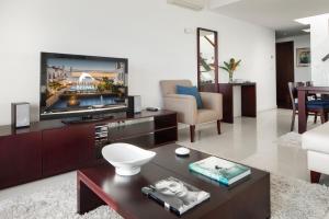 a living room with a tv and a couch at Belmar Spa & Beach Resort in Lagos
