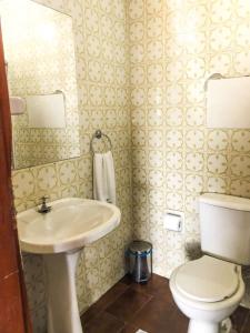 a bathroom with a sink and a toilet at Pousada Colonial Penedo - Alagoas in Penedo