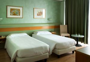 Posteľ alebo postele v izbe v ubytovaní Hotel Leonardo da Vinci