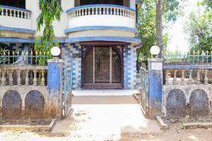 an entrance to a building with a blue gate at Ronak Cottage in Lonavala