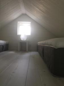 a attic room with a bed and a window at Annexet in Jönköping