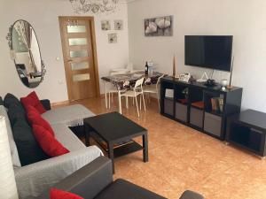 a living room with a couch and a table at Arenales del Sol in Arenales del Sol