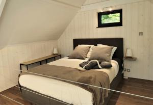 a bedroom with a large bed in a room at Les Kabanes de Kerforn in Crach