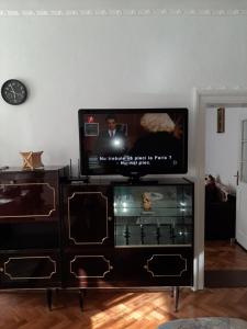 a flat screen tv sitting on top of a entertainment center at Alex-Gabriel in Sibiu