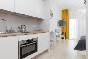 a kitchen with a sink and a stove top oven at Yellow Sunset Studio in Warsaw