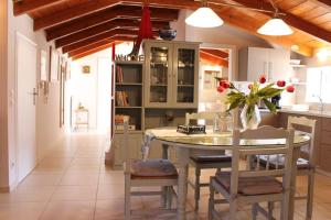 a kitchen with a table and chairs in a room at New independent loft, 360⁰ view, 5' beach/center in Kalamata