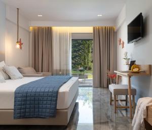 a bedroom with a bed and a table and a desk at Notia Luxury Living in Porto Koufo