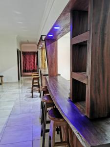a bar with wooden bar stools in a room at Upper Inchaban beachfront apartment in Inchaban