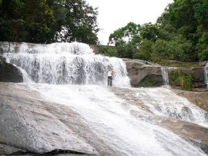 a person standing in front of a waterfall at Mata Atlântica Park Hotel in Matinhos +66 photos