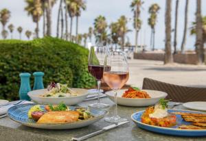 a table topped with plates of food and drinks at Casa Del Mar in Los Angeles