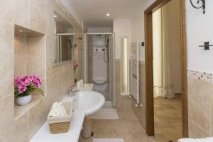 a bathroom with a sink and a shower at Sara luxury apartament 2 in Sorrento +16 photos