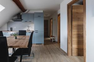 a kitchen and dining room with a wooden table in a room at APARTMAJI GORENC in Bled