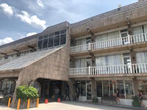 a building with people standing outside of it at HOTEL PLAZA RIVIERA in Matamoros