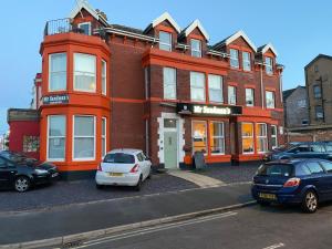 a building with cars parked in front of it at Mr sandman’s hotel in Blackpool