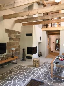 a living room with a fireplace and a stone wall at Dom Kopaczówka - sauna, home spa in Wünschelburg