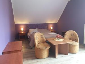 a room with a table and chairs and a bed at Gospodarstwo Agroturystyczne Damroka in Szymbark