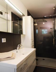 a bathroom with a sink and a shower at Am sonnigen Waldrand in Innsbruck