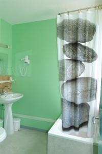 a bathroom with a towel rack in a shower at Hotel du Donjon in Champlitte-et-le-Prélot