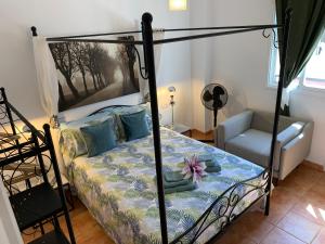 a bedroom with a canopy bed and a chair at Dream Ravine in Santa Cruz de Tenerife