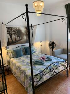 a bedroom with a bed with a metal canopy at Dream Ravine in Santa Cruz de Tenerife