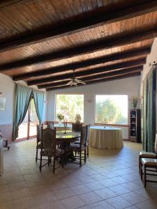 a dining room with a table and a table and chairs at Tenuta La Volpe in Miglionico