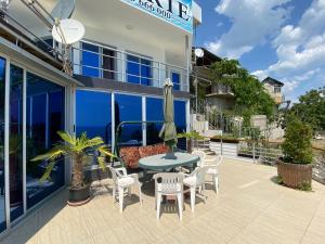 a patio with a table and chairs on the side of a building at Villa Jackie in Golden Sands