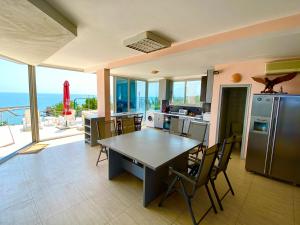 a kitchen with a table and a view of the ocean at Villa Jackie in Golden Sands
