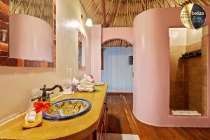 a bathroom with a sink and a mirror at Portofino Beach Resort-An Authentic Island Escape! in San Pedro