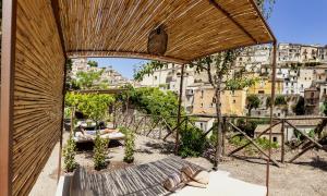 a view from the balcony of a house with a view of a city at Iblaresort Boutique Hotel in Ragusa