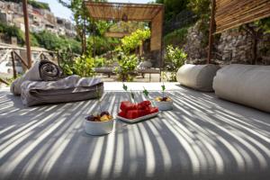 a table with two bowls of fruit on it at Iblaresort Boutique Hotel in Ragusa