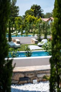 a view of a swimming pool in a garden at SunBlue Boutique Villas in Skala Rachoniou