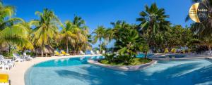 a pool at a resort with palm trees and chairs at Portofino Beach Resort-An Authentic Island Escape! in San Pedro