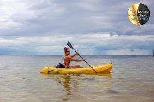 a man in a yellow kayak in the water at Portofino Beach Resort-An Authentic Island Escape! in San Pedro
