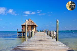a pier leading to a house on the water at Portofino Beach Resort-An Authentic Island Escape! in San Pedro